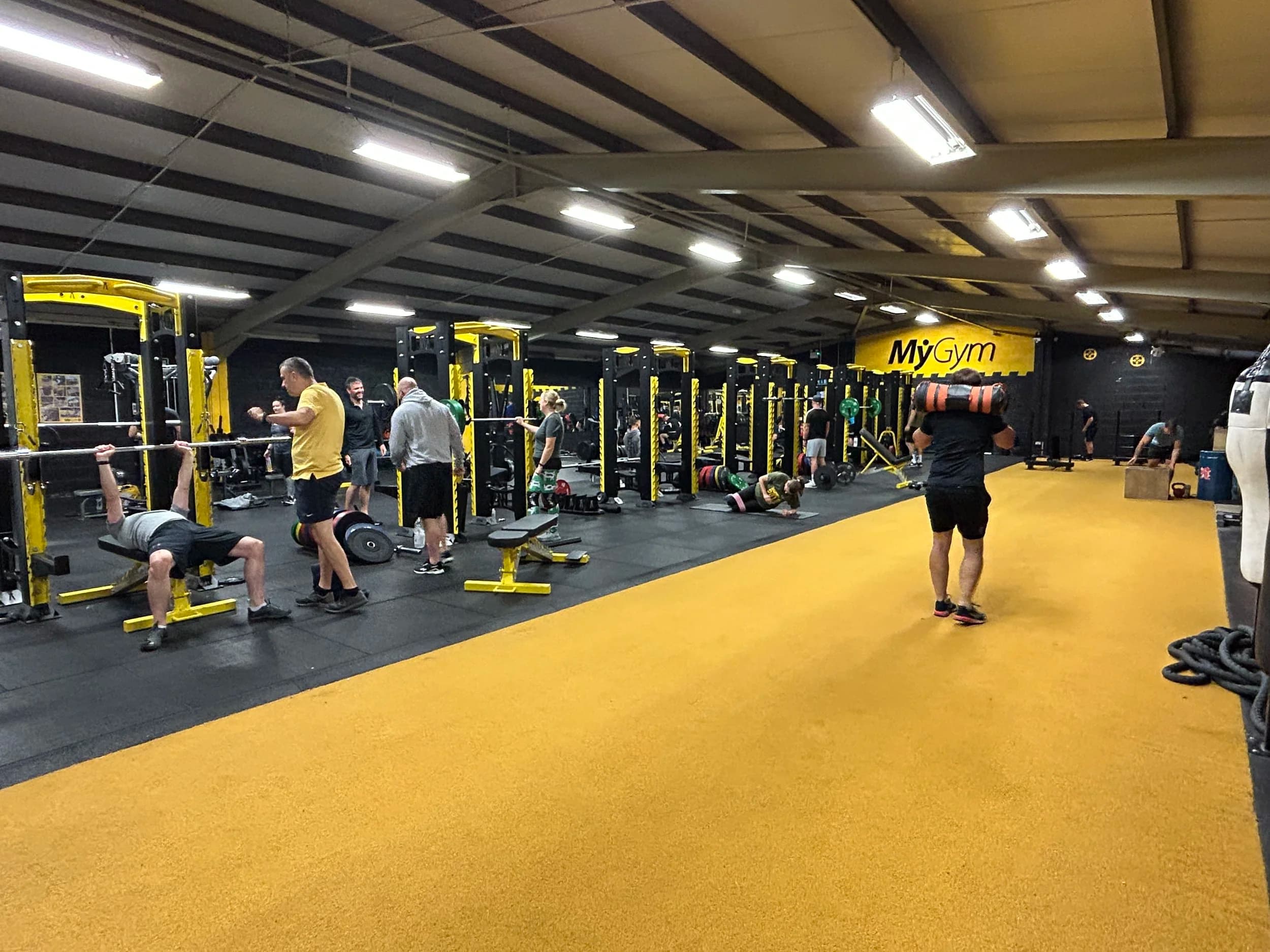 MyGym member training with barbell and rack setup